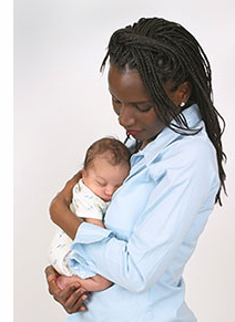 image of adult african american female holding tiny infant.
